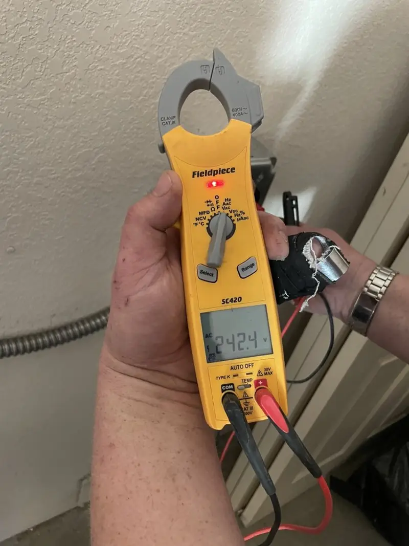 Voltage testing with clamp meter during Recessed Lighting Installation in Eden
